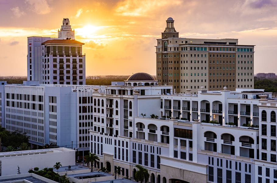 Coral Gables skyline with Mediterranean-style buildings beneath a golden sunset